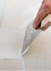 Spreading flooring adhesive with a notched trowel