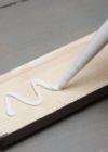 Applying grab adhesive to a timber board