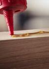 Applying wood adhesive along a timber edge