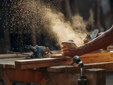 Woodworking repair project in progress using hand tools to restore a wooden surface