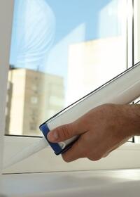 Applying sealant around a window frame to help prevent drafts and moisture penetration